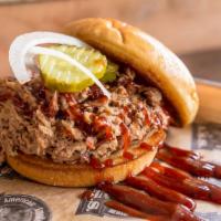 Pulled Pork On a Bun · Tenderly smoked in-house, rubbed and shredded. Served with choice of 1 side and choice of bu...