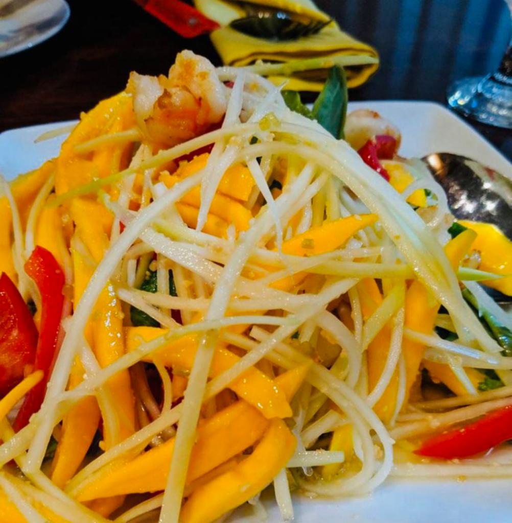 Grilled Shrimp with Mango Salad · Grill shrimp with mango, raw papaya, cilantro, red bell pepper and crunch peanut with thai spicy vinaigrette dressing