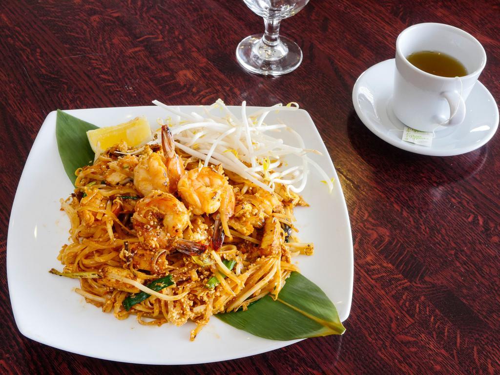 58. Pad Thai · Stir fried thin Thai rice noodles with egg, crushed peanuts chopped turnips, tofu, scallions and bean sprouts, served with raw bean sprouts and lemon.