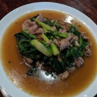 61. Pad Lard Nar · Stir fried broad rice noodles with eggs, Chinese broccoli, topped with brown gravy.