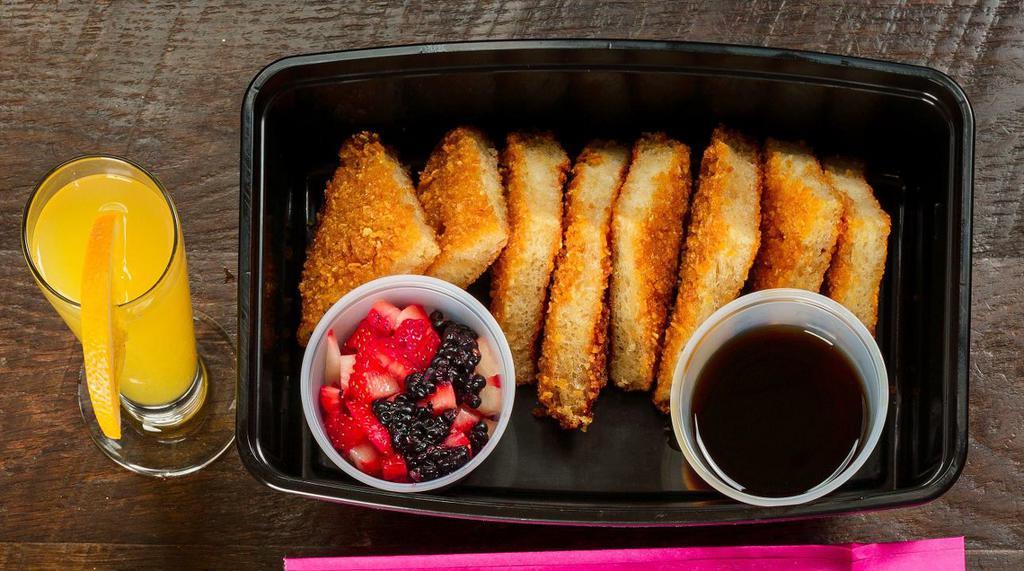 Churros French Toast · Mexican donut crusted French toast topped with fresh berries and served with piloncillo syrup.