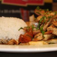 Pollo Saltado · Strips of chicken sauteed with onions, tomatoes in a soy sauce served with fries and white r...