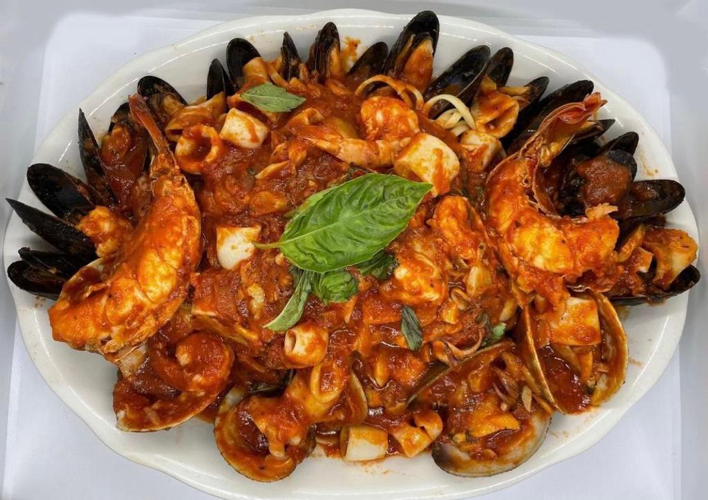 Seafood Fra Diavolo · Serves two. One lobster tail, shrimp, clams, calamari, scungilli, and mussels sauteed in a spicy marinara sauce. Served over linguine and with a salad.