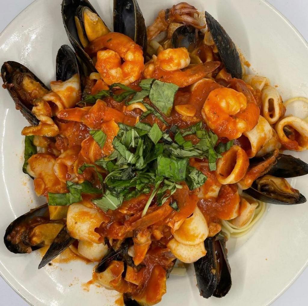 Seafood Marinara · Shrimp, mussels, scungilli, calamari and sauteed in a marinara sauce. Served over linguine and with a salad.