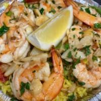 Shrimp Scampi over Rice · Large shrimp, seasoned in butter garlic, wine and lemon. Served with a salad and choice of v...