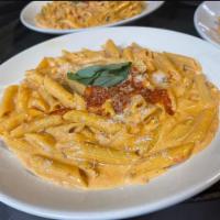 Penne alla Vodka · Penne pasta served in our special recipe and topped with a little red prosciutto sauce.