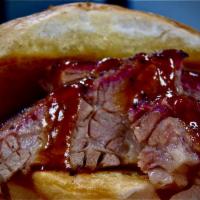 Brisket Sandwich with 1 Side · Certified Angus Brisket on a sweet sourdough bun. Comes with your choice of one side and a s...