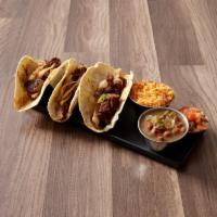 Tacos al Carbon · 3 steak or chicken fajita tacos in warm flour or corn tortillas and topped with grilled onio...