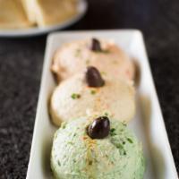 Hummus Trio · Choice of three from traditional, roasted red pepper, roasted garlic, jalapeño cilantro, smo...