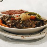 Braised Ox Tails Dinner · USDA Choice Ox Tails Braised for over 4 hours with Tender Care, White Potatoes and Other Gar...
