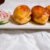 Curry Puffs · Crispy veggie-filled puffs (three) with cucumber relish.