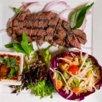 Crying Tiger · Grilled tenderloin beef sliced and served with papaya salad, sticky rice and Thai spicy dipp...