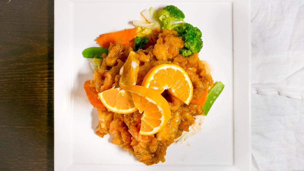 Orange Chicken · Lightly battered tender chicken sauteed in sweet orange chili sauce and served with jasmine rice and steamed veggies.