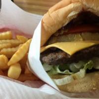 #4. Island Burger Combo · 1/4 lb. patty with pickle, lettuce, tomato, BBQ sauce, and a grilled pineapple ring on a ses...