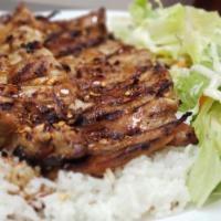 Beef Teriyaki · Grilled marinated beef on a bed of steamed white rice and drizzled in homemade teriyaki serv...