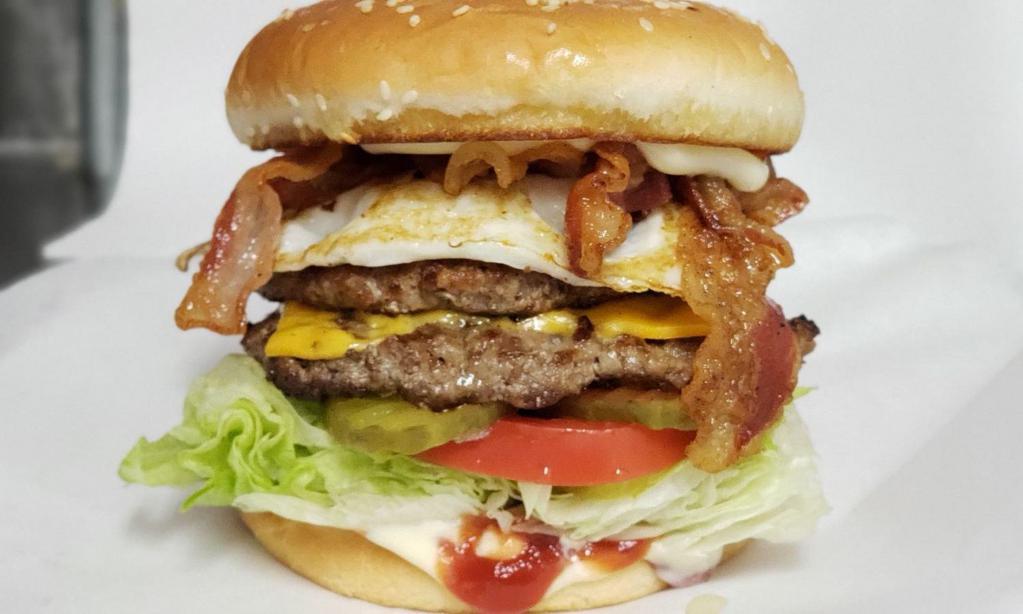 Breakfast Burger · 1/4 lb. beef patty with bacon, cheese, tomato, pickle, lettuce, a fried egg, ketchup and mayo.