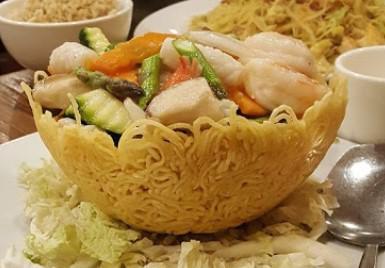 Lover's Nest Yaya Specialties · Beef, chicken, asparagus, snow peas, carrots, and baby corn in brown sauce, served in basket made of crispy noodle.
