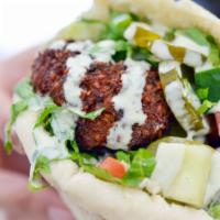 Red Hot Chili Sandwich · Roasted pepper falafel, hummus, lettuce, Israeli salad and pickles. Vegan. Spicy.