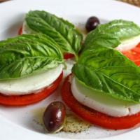 Caprese Salad · Sliced tomato, fresh mozzarella, Kalamatta olives, artichoke, basil and balsamic vinegar.