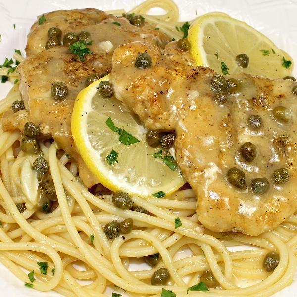 Chicken Piccata · Chicken sauteed in lemon butter, capers and white wine sauce over pasta.