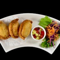 Curry Puff · Deep fried puff pastry stuffed with potato, onions and chunks of chicken seasoned in curry p...