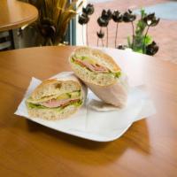 Carlyle Sandwich Specialty · Smoked turkey breast, Swiss cheese, avocado, tomato and horseradish mayo on a baguette.