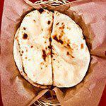 Naan · Traditional Indian style tandoori bread in a teardrop shape.