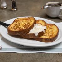 Grand French Toast · Thick sliced brioche cooked in our own batter of vanilla, eggs, brown sugar, cinnamon, and f...