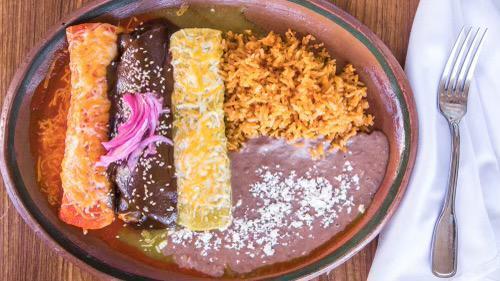 Enchiladas Milagro( Serve with Rice and Beans  · Red,Green and Mole Enchiladas with rice and beans.