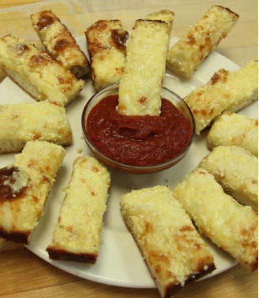 Perry's Sticks with Mozzarella · Hot buttered bread topped with mozzarella and Parmesan cheeses with a hint of garlic. Served with pizza sauce for dipping.