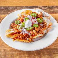 Chorizo Chili Nachos · Fresh fried tortilla chips topped with mozzarella and cheddar, diced red onion and tomato, h...