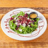 Beet and Goat Cheese Salad · Roasted beets, crumbled goat cheese, arugula, orange vinaigrette, and balsamic reduction.