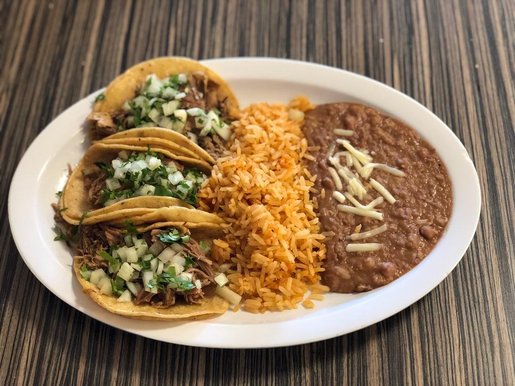 Taco Platillo · 3 tacos with a side of rice, beans, chips and salsa.