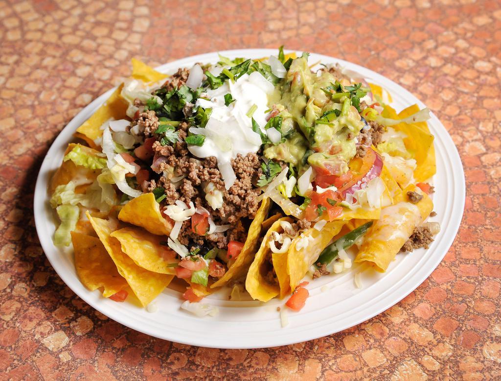 Special Nacho · Chips, cheese, queso, meat, beans, guacamole, pico salsa and sour cream.