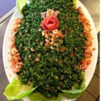 Tabbouleh Salad · Fresh chopped parsley mixed with bulgur wheat, mint, tomatoes, green onions, lemon juice and...