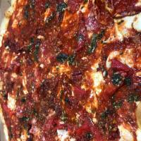 Affumicata Pizza · Smoked mozzarella, san marzano tomato and basil sauce topped with sun-dried tomatoes, tomato...