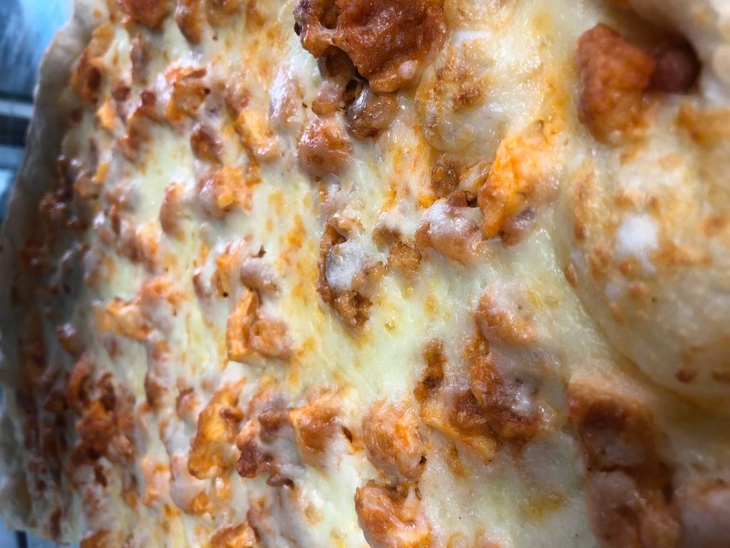 Buffalo Chicken Pizza · Grilled chicken with our famous Buffalo sauce, mozzarella and bleu cheese dressing drizzled on. Round pizza.