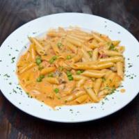 Penne Vodka · With prosciutto, peas and mushrooms. 