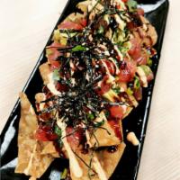 Nacho · Wonton chips topped with ahi tuna, green onion, avocado and mixed with ponzu, nikiri soy, se...