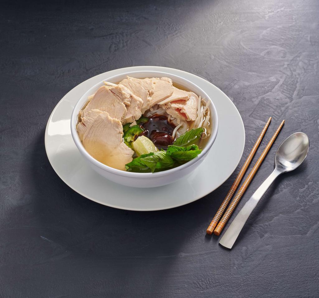 Chicken Pho · Savory Vietnamese-style chicken broth ladled over rice noodles and sliced chicken breast. Served with a side of beansprouts, jalapenos, lime wedge and Asian basil. Gluten free.