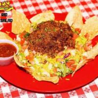 Del Rio Taco Salad · Taco meat, tomatoes, cheddar cheese, chives and 'tilla chips.