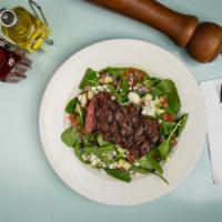 Lucille's Steakhouse Salad · Fresh spinach, romaine lettuce, diced tomatoes, diced cucumbers, diced red onion, sliced gri...