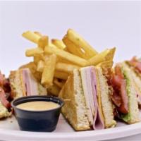 Classic Club Sandwich · Fresh turkey, ham, Swiss and American cheeses, applewood smoked bacon, lettuce, tomato, basi...