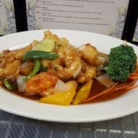 P12. Sweet and Sour Shrimp · Deep-fried shrimp are stir-fried with tomatoes, cucumbers, onions, and scallions in sweet an...