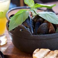 Lemongrass Mussels · PEI mussels, lemongrass and Sauvignon Blanc - coconut broth with grilled banh mi bread.