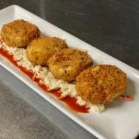 Crispy Deviled Eggs · panko crusted, flash fried deviled eggs
with hot sauce and coleslaw