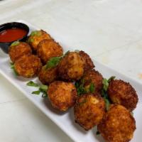 Cauli Tots · buffalo style cauliflower tots with cheese blend, topped with green onions, buffalo and butt...