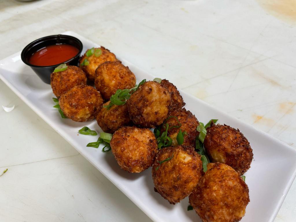 Cauli Tots · buffalo style cauliflower tots with cheese blend, topped with green onions, buffalo and buttermilk parmesan for dipping