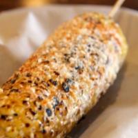 Mexican Street Corn · Grilled corn on the cob with lime, cream, cheese and chile powder.