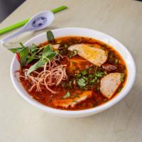 28. Spicy Hue Style Noodle Soup · Bun bo hue. Spicy rice noodle soup with beef shanks, pork feet, Vietnamese pork roll and pig...